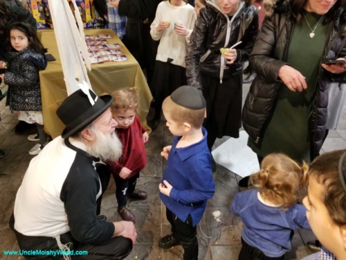 Uncle Moishy shares a moment with some young fans.