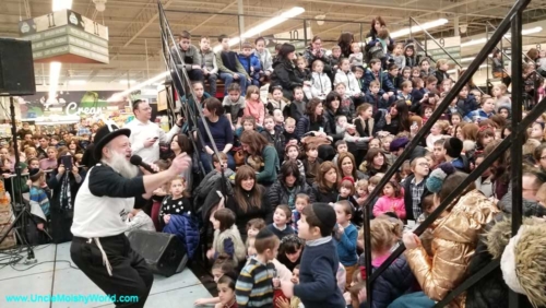 Moishy Tanenbaum, the original Uncle Moishy performing to a large audience of happy Jewish children.